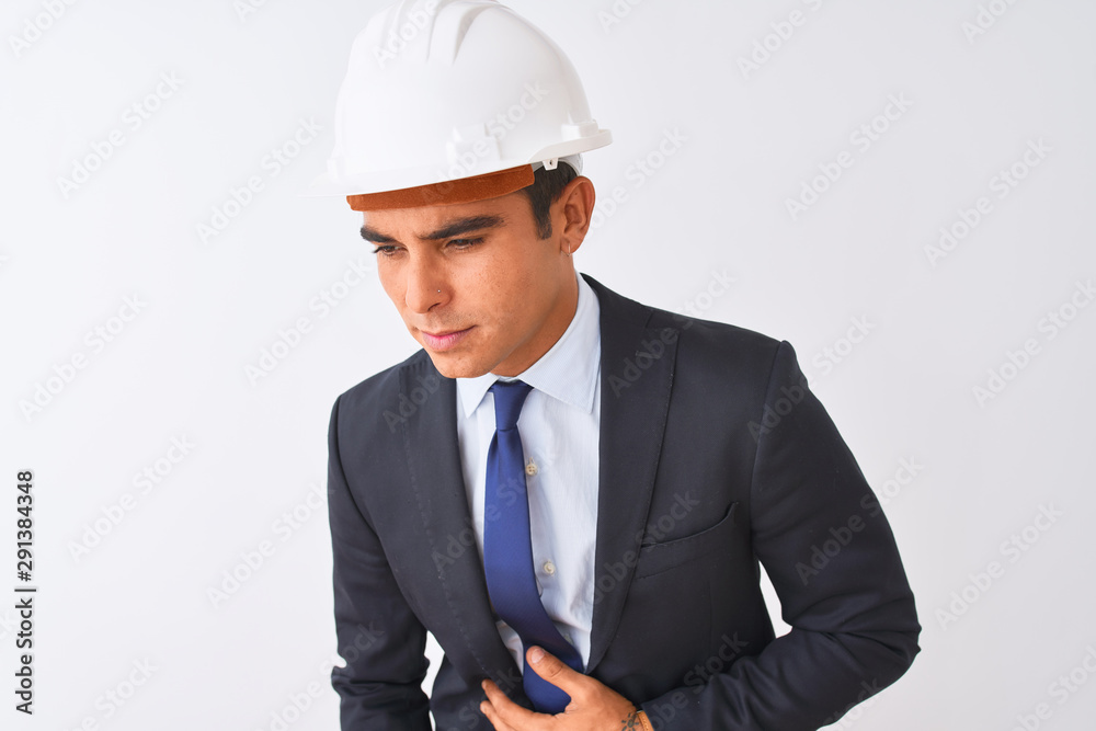 Young handsome architect man wearing suit and helmet over isolated white background with hand on stomach because nausea, painful disease feeling unwell. Ache concept. Young handsome architect man wearing suit and helmet over isolated white background with hand on stomach because nausea, painful disease feeling unwell. Ache concept.