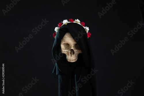 Death wearing a crown of flowers and a black robe
