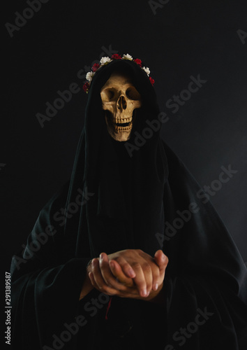 Death wearing a crown of flowers and a black robe