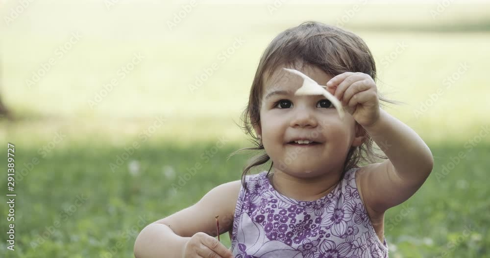 Cute baby girl exploring a park in late summer. Shot in 4K RAW on a cinema camera. Cute baby girl exploring a park in late summer. Shot in 4K RAW on a cinema camera.