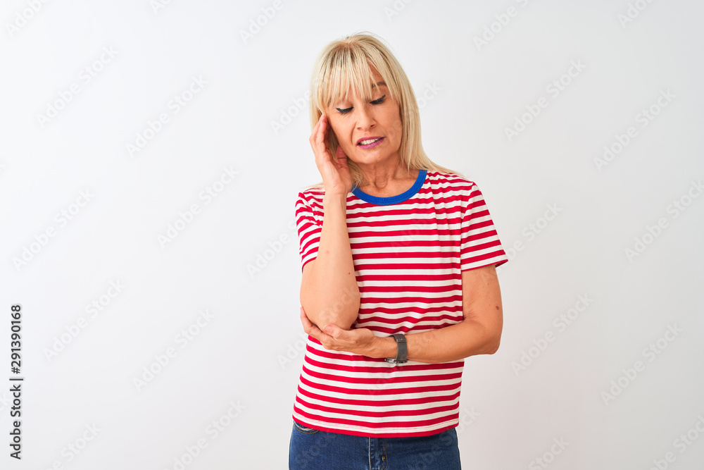 Middle age woman wearing casual striped t-shirt standing over isolated white background thinking looking tired and bored with depression problems with crossed arms. Middle age woman wearing casual striped t-shirt standing over isolated white background thinking looking tired and bored with depression problems with crossed arms.