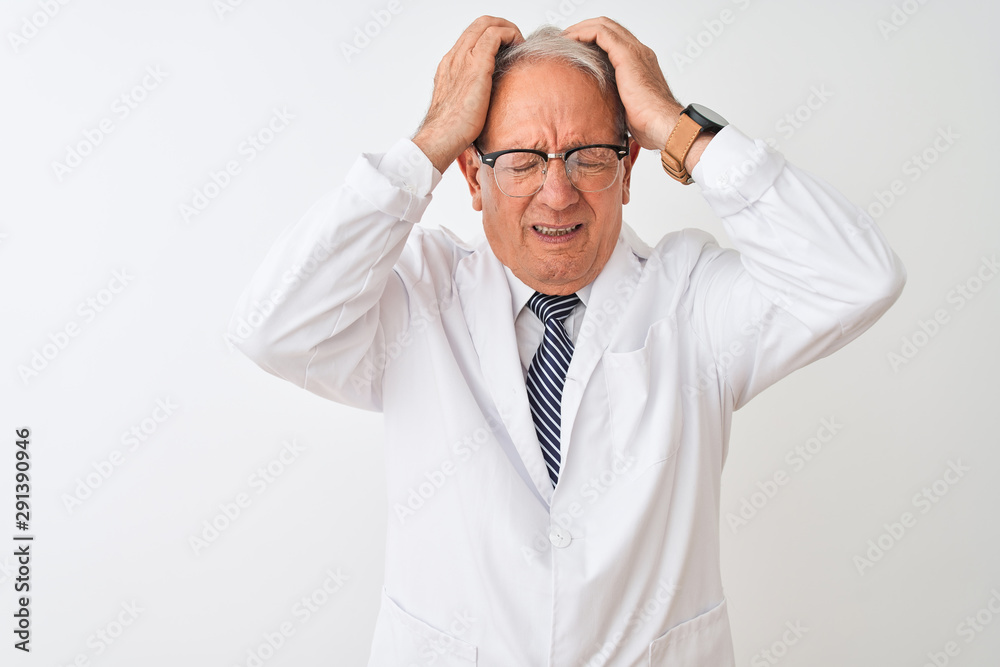 Senior grey-haired scientist man wearing coat standing over isolated white background suffering from headache desperate and stressed because pain and migraine. Hands on head. Senior grey-haired scientist man wearing coat standing over isolated white background suffering from headache desperate and stressed because pain and migraine. Hands on head.