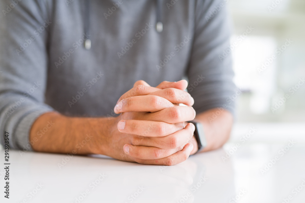 Naklejka premium Close up of man with crossed hands over white table