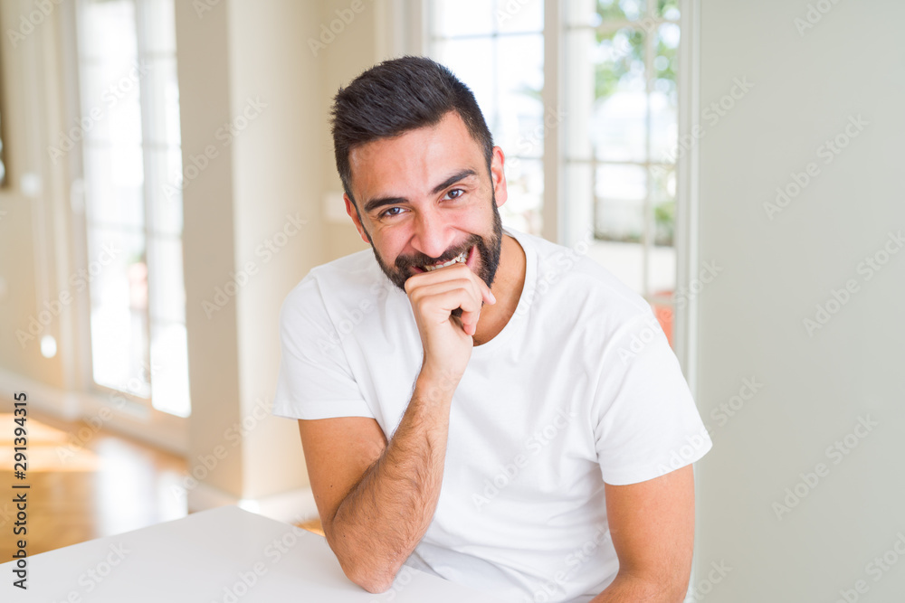 Handsome man smiling cheerful with a big smile on face showing teeth, positive and happy expression Handsome man smiling cheerful with a big smile on face showing teeth, positive and happy expression