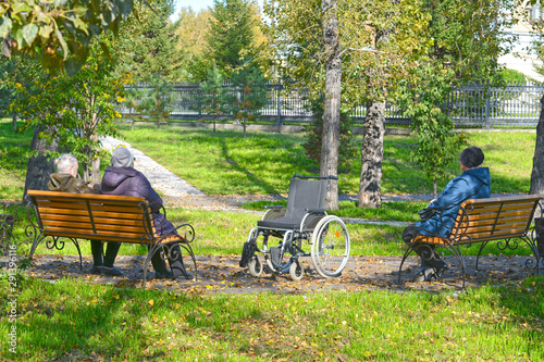 Elderly women (with disabilities) for a walk in the park. Autumn. Russia