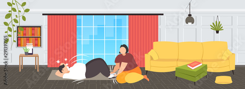 fat man doing sit-ups abdominal exercises with overweight woman holding his legs obese couple training together workout weight loss concept modern living roo interior flat full length horizontal