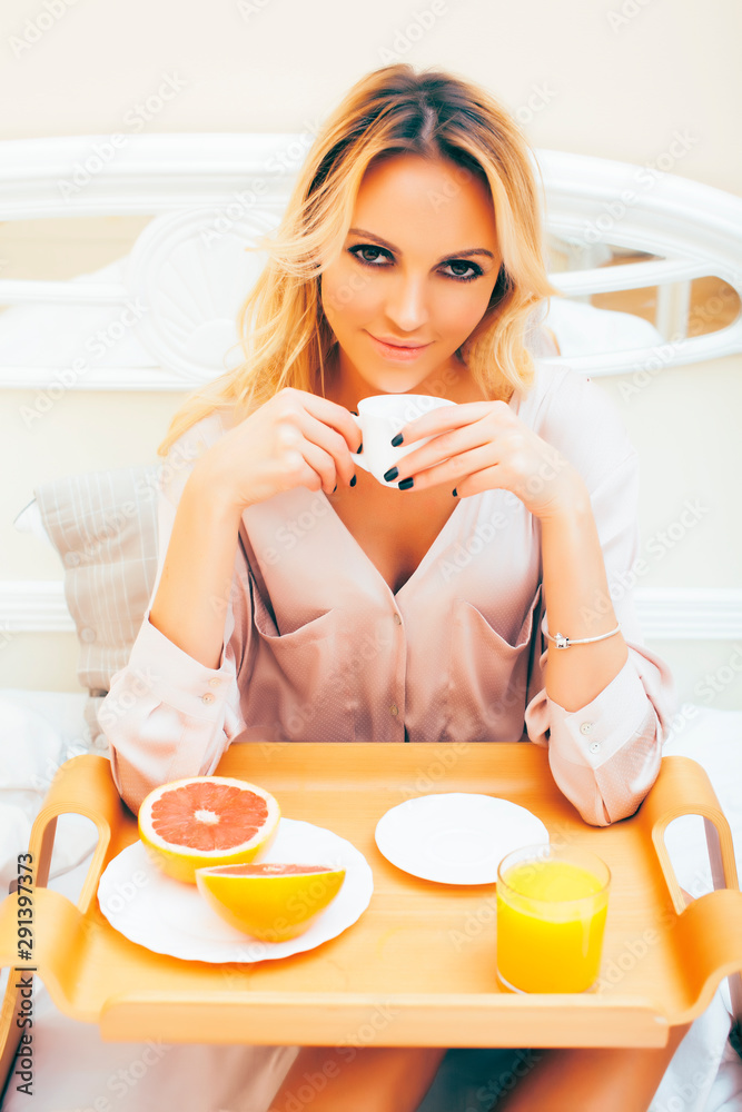 young beauty blond woman having breakfast in bed early sunny morning, princess house interior room, healthy lifestyle concept young beauty blond woman having breakfast in bed early sunny morning, princess house interior room, healthy lifestyle concept