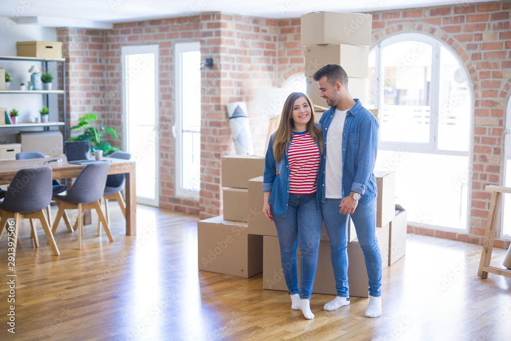 Young beautiful couple in love moving to new home, very happy and cheerful for new apartment Young beautiful couple in love moving to new home, very happy and cheerful for new apartment