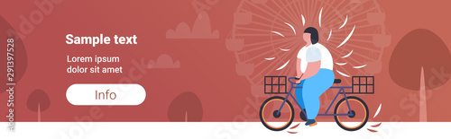 fat obese woman riding bike overweight girl cycling bicycle weight loss concept public park ferris wheel background copy space horizontal flat full length