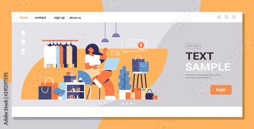 woman with laptop using computer application online shopping concept big fashion shop female clothes boutique interior flat full length copy space