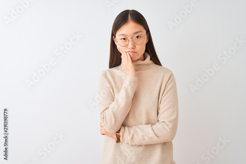 Young chinese woman wearing turtleneck sweater and glasses over isolated white background thinking looking tired and bored with depression problems with crossed arms. © Krakenimages.com