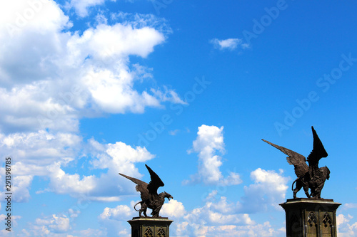Statues of Griffin or Griffon against the sky. A legendary creature with the body of a lion, the head and wings of an eagle. Ancient mythology fantasy.