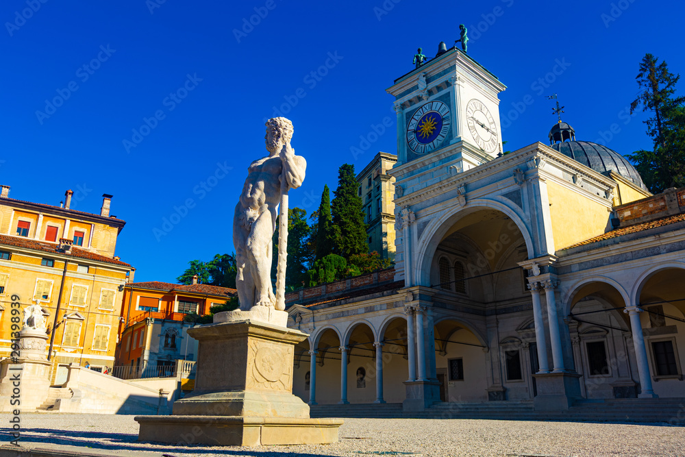 Church and clock tower on Piazza liberta, Udine, Italy