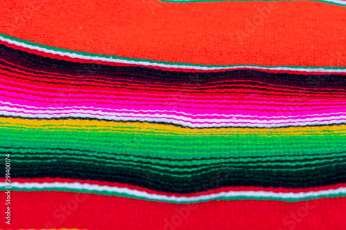 Sarape, zarape o jorongo es una prenda de hombre usada por el hombre del campo para cubrirse de la lluvia y el frío, es un traje mexicano de la ciudad de Saltillo. Sirve como refugio, manta o alfombra photo
