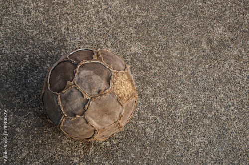 Very old ball on concrete ground