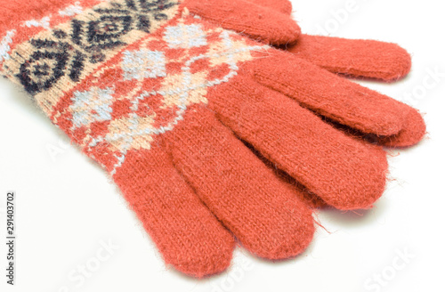 Red woolen gloves on white background. Womanly clothes