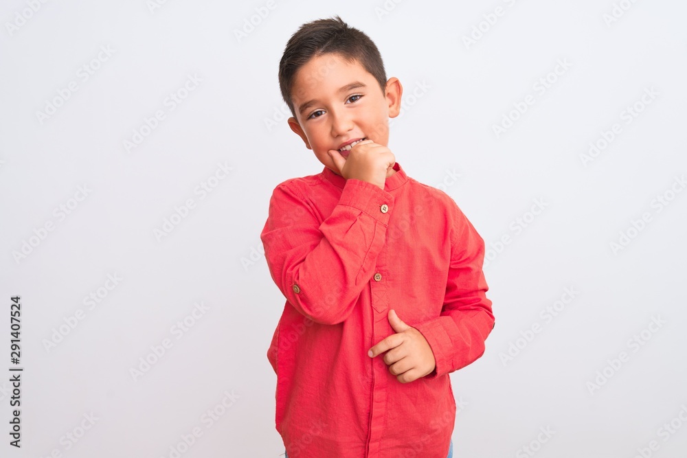 Beautiful kid boy wearing elegant red shirt standing over isolated white background looking confident at the camera smiling with crossed arms and hand raised on chin. Thinking positive. Beautiful kid boy wearing elegant red shirt standing over isolated white background looking confident at the camera smiling with crossed arms and hand raised on chin. Thinking positive.