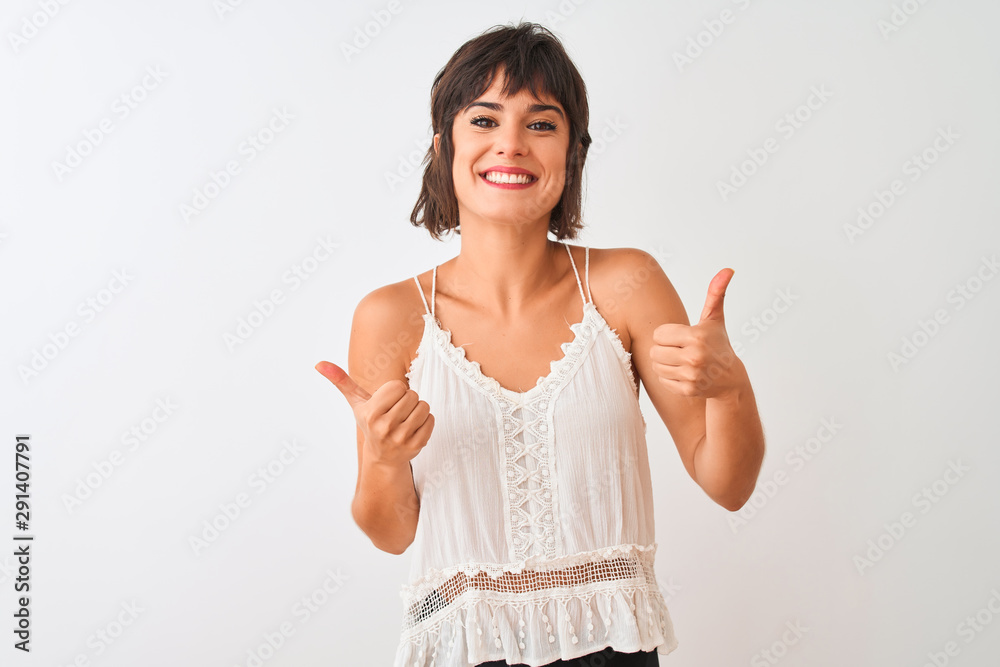 Young beautiful woman wearing summer casual t-shirt standing over isolated white background success sign doing positive gesture with hand, thumbs up smiling and happy. Cheerful expression Young beautiful woman wearing summer casual t-shirt standing over isolated white background success sign doing positive gesture with hand, thumbs up smiling and happy. Cheerful expression
