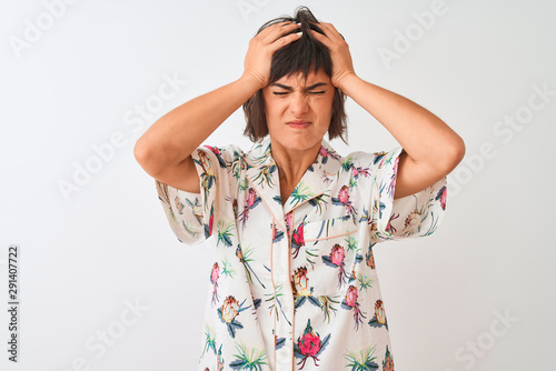 Beautiful woman on vacation wearing summer casual shirt over isolated white background suffering from headache desperate and stressed because pain and migraine. Hands on head. © Krakenimages.com
