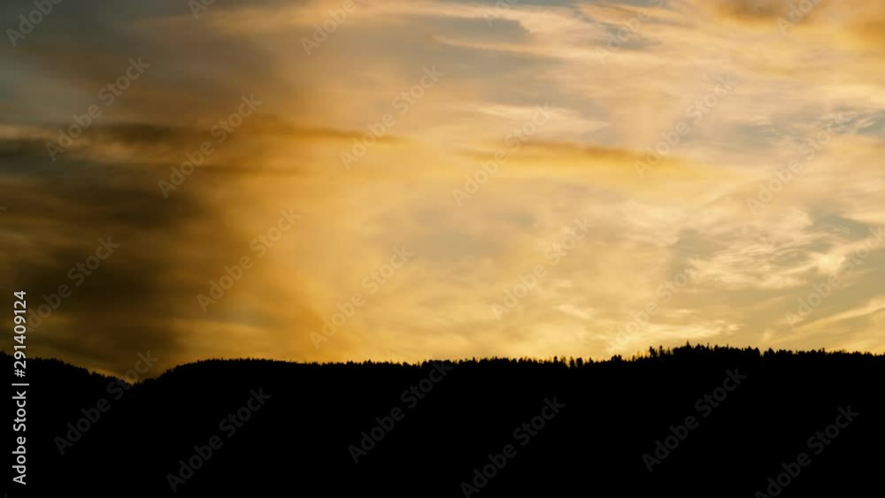 A black mountain ridge with a beautiful and dramatic orange sky. A black mountain ridge with a beautiful and dramatic orange sky.