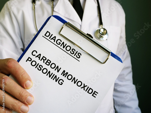 Doctor holds diagnosis Carbon monoxide poisoning. photo