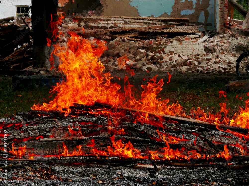 Fire at a construction site. Flames of fire against the backdrop of ruins. Fire at a construction site. Flames of fire against the backdrop of ruins.