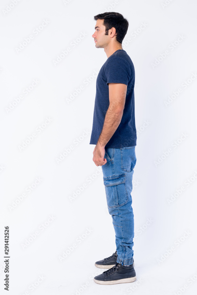 Full body shot profile view of young handsome Persian man Full body shot profile view of young handsome Persian man