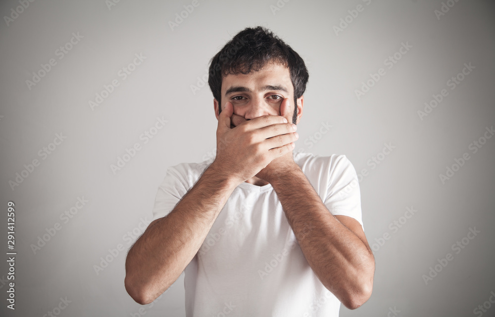 Caucasian man covering his mouth with hands. Secret Caucasian man covering his mouth with hands. Secret
