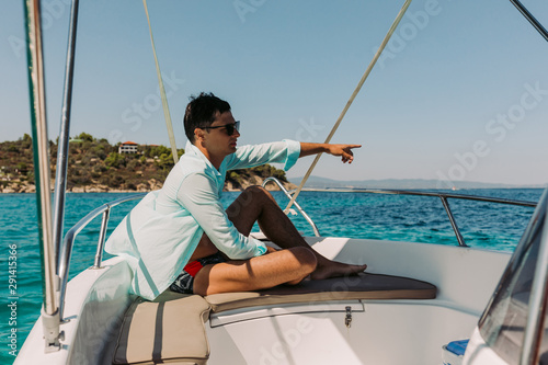 man relaxing on yacht in the sea. man on board of boat in Greece © producer