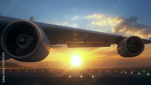 Camera moving close to airplane wing showing its engines rotating. The airplane is on runway and ready to start taking off procedure. Beautiful sunset seen behind the airplane.