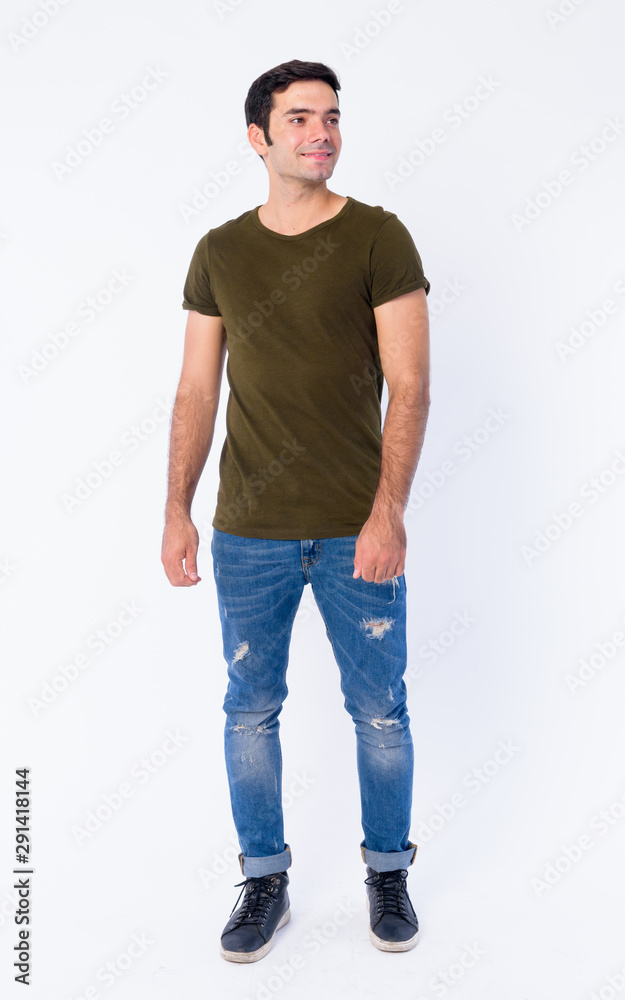Full body of happy young handsome Persian man thinking Full body of happy young handsome Persian man thinking