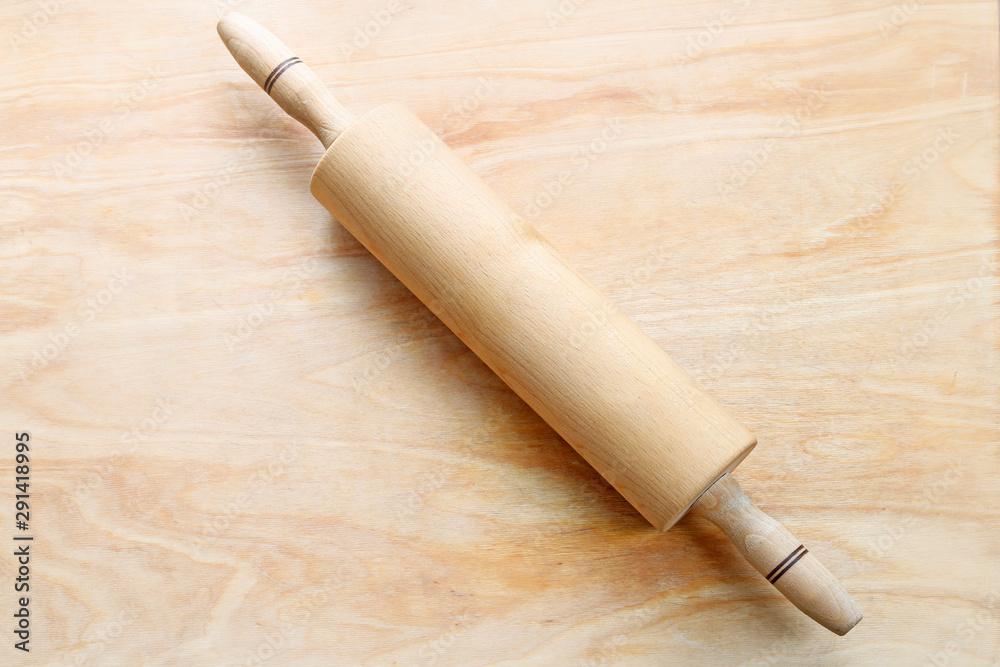 Traditional rolling pin on wooden background