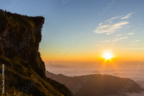 sunset sky over mountain and beautiful sunrise on white fog in the morning