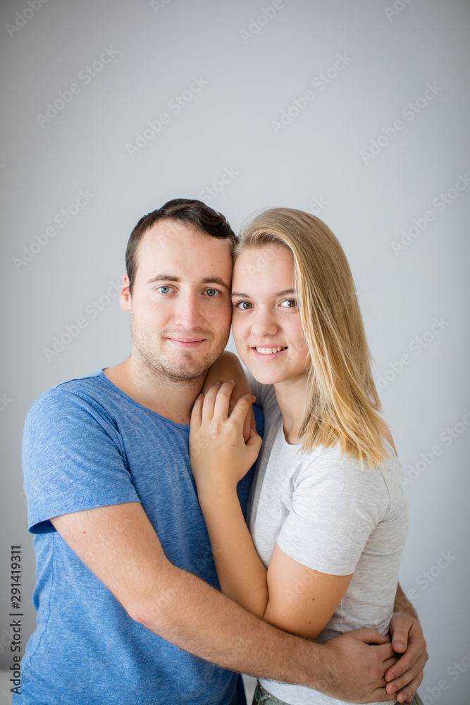 Brother and sister posing for a photo together. Hugging and smiling, feeling caring and loved. Brother and sister posing for a photo together. Hugging and smiling, feeling caring and loved.