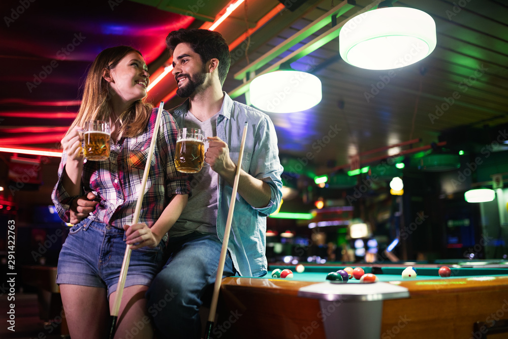 Couple drinking beer and playing snooker on date Couple drinking beer and playing snooker on date