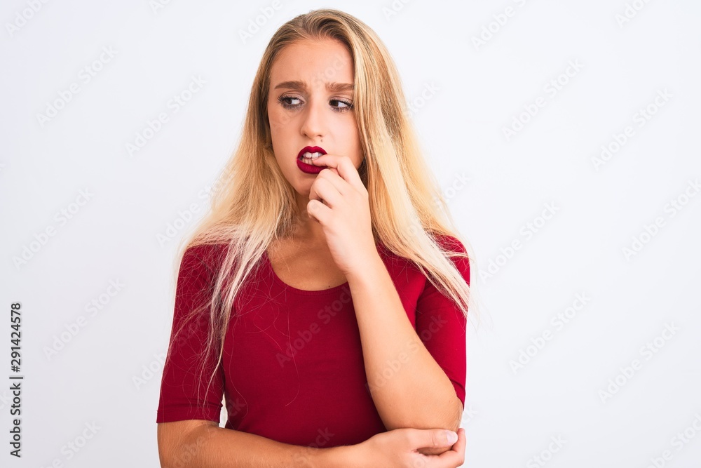Young beautiful woman wearing red t-shirt standing over isolated white background looking stressed and nervous with hands on mouth biting nails. Anxiety problem. Young beautiful woman wearing red t-shirt standing over isolated white background looking stressed and nervous with hands on mouth biting nails. Anxiety problem.