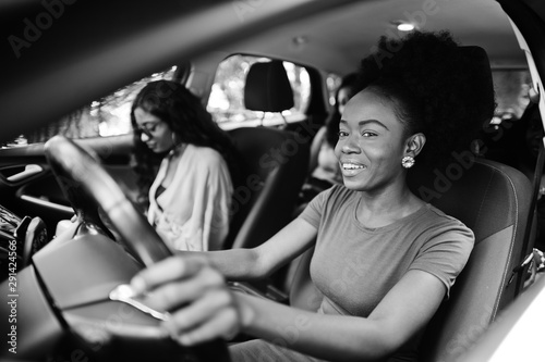 Group of african american girls friends having fun in the car.