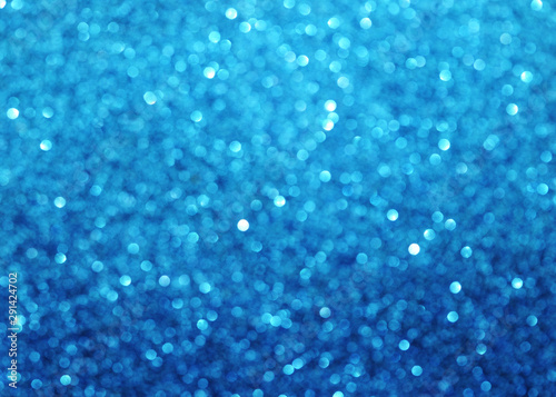 Blurred texture of glitter's paper. Festive background.