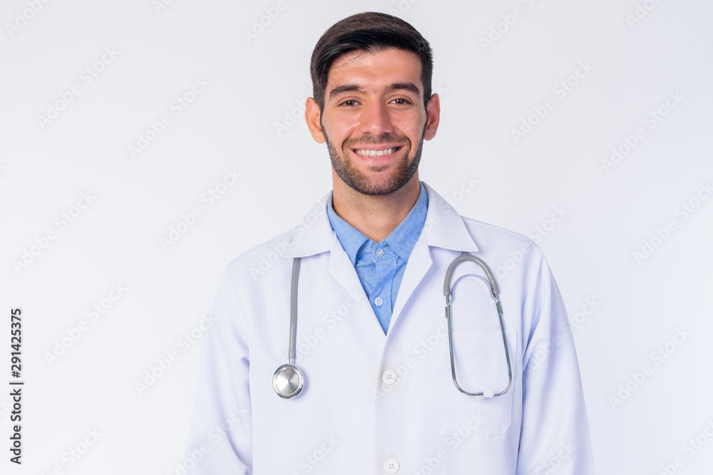 Face of happy young bearded Persian man doctor smiling Face of happy young bearded Persian man doctor smiling