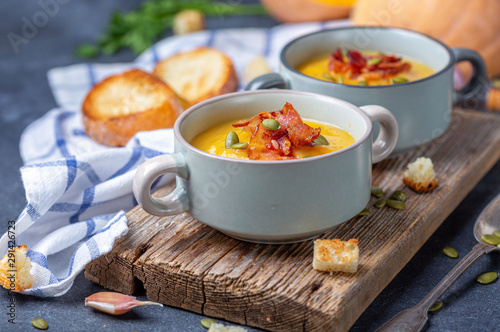 Pumpkin soup with bacon in a rustic style. photo