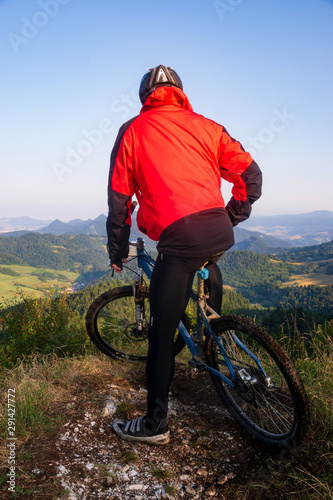 Velky Lipnik, Pieniny National Park, Slovakia-July 2019: Cyclist observing the landscape from the top of the mountain