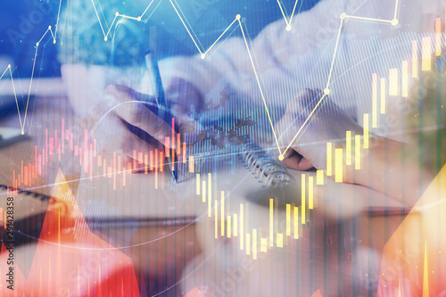 Wallpaper Mural Financial forex graph displayed on hands taking notes background. Concept of research. Multi exposure Torontodigital.ca