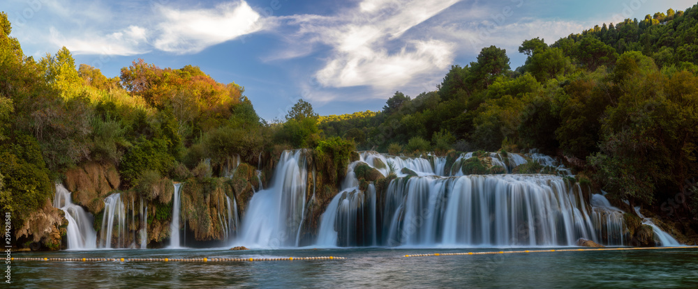 Krka National Park-panorama of the waterfall against the beautiful evening sky - obrazy, fototapety, plakaty 