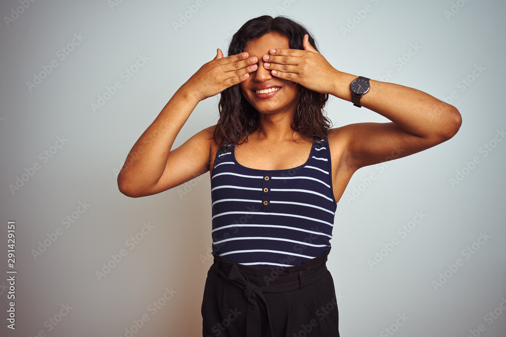Transsexual transgender woman wearing striped t-shirt over isolated white background covering eyes with hands smiling cheerful and funny. Blind concept. Transsexual transgender woman wearing striped t-shirt over isolated white background covering eyes with hands smiling cheerful and funny. Blind concept.
