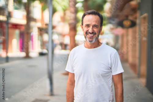 Middle age handsome man standing on the street smiling © Krakenimages.com