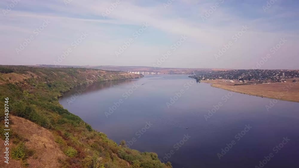 Top view of Dnestr (Dniester) river in autumn. River surrounds yellow field and green forest. Moldova republic of. Top view of Dnestr (Dniester) river in autumn. River surrounds yellow field and green forest. Moldova republic of.