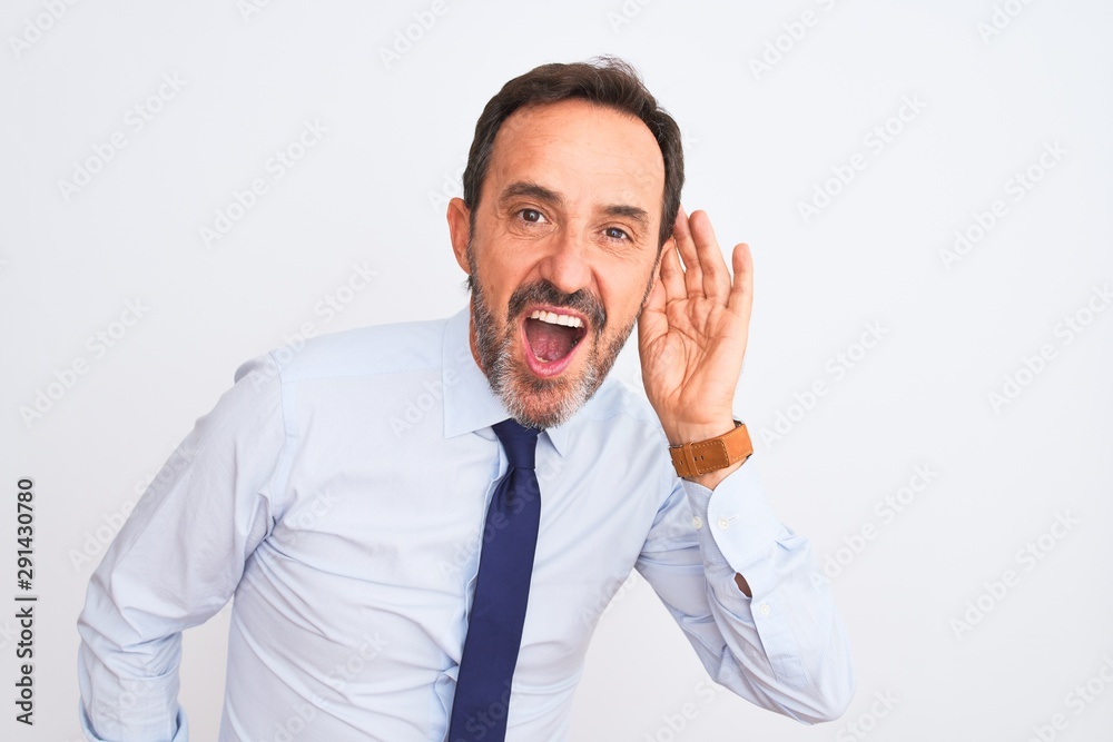 Middle age businessman wearing elegant tie standing over isolated white background smiling with hand over ear listening an hearing to rumor or gossip. Deafness concept. Middle age businessman wearing elegant tie standing over isolated white background smiling with hand over ear listening an hearing to rumor or gossip. Deafness concept.