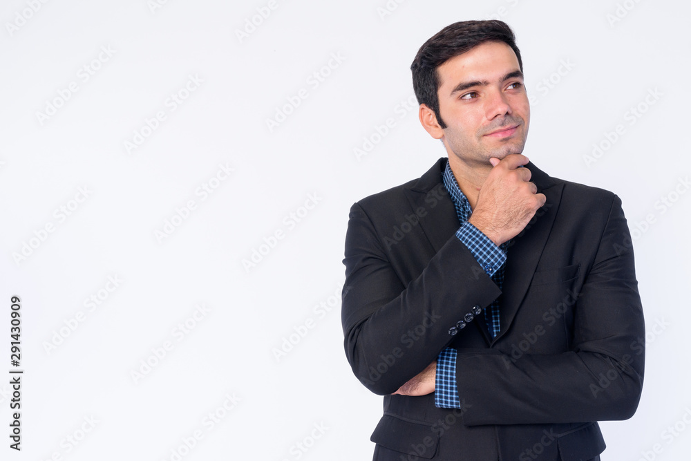 Portrait of young handsome Persian businessman in suit thinking Portrait of young handsome Persian businessman in suit thinking