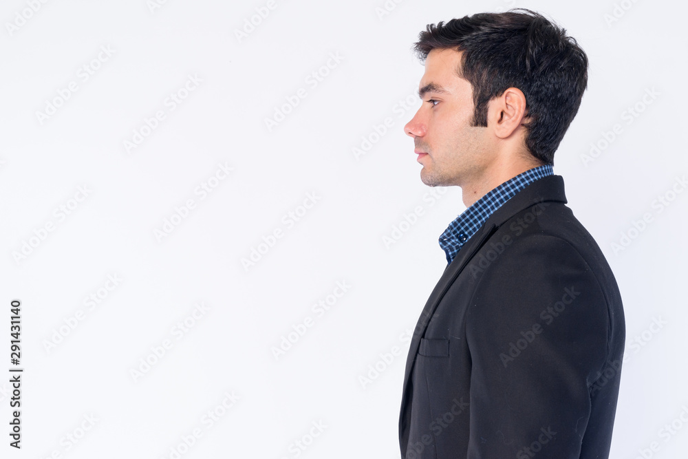 Closeup profile view of young handsome Persian businessman in suit Closeup profile view of young handsome Persian businessman in suit