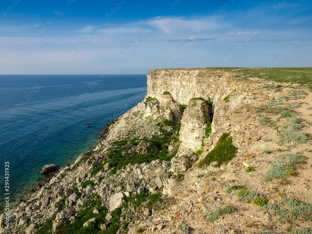Section of sea coast with steep textured limestone rocks